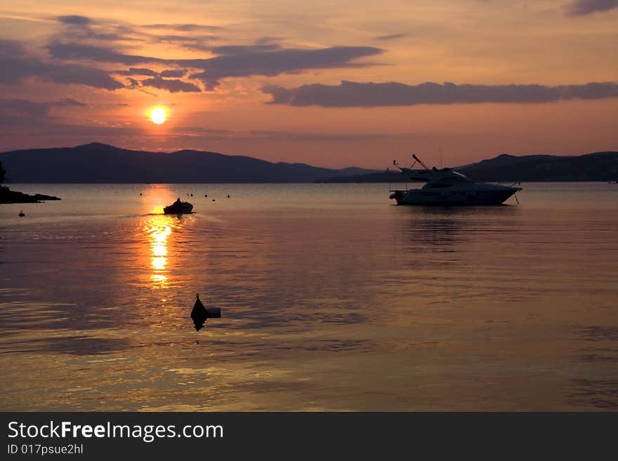 Sunset at the small bay against a background of mountains. Sunset at the small bay against a background of mountains