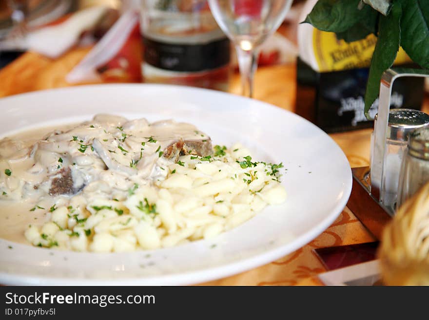 A restaurant in Germany with Bavarian steak with champignons. A restaurant in Germany with Bavarian steak with champignons