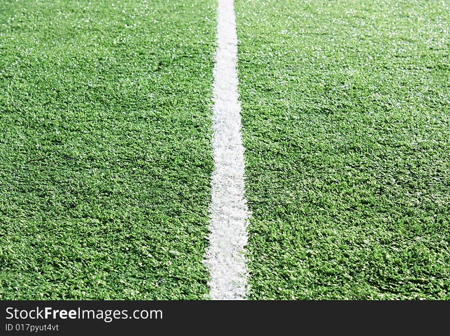 White stripe on an artificial grass of stadium. White stripe on an artificial grass of stadium