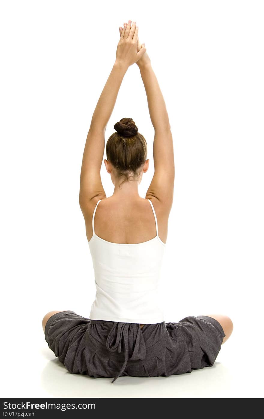 Young woman doing yoga on an isolated background