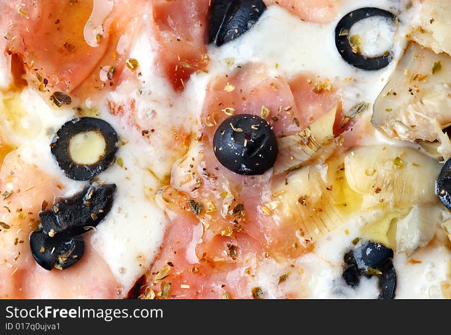 Extreme closeup of italian pizza with bacon and artichokes