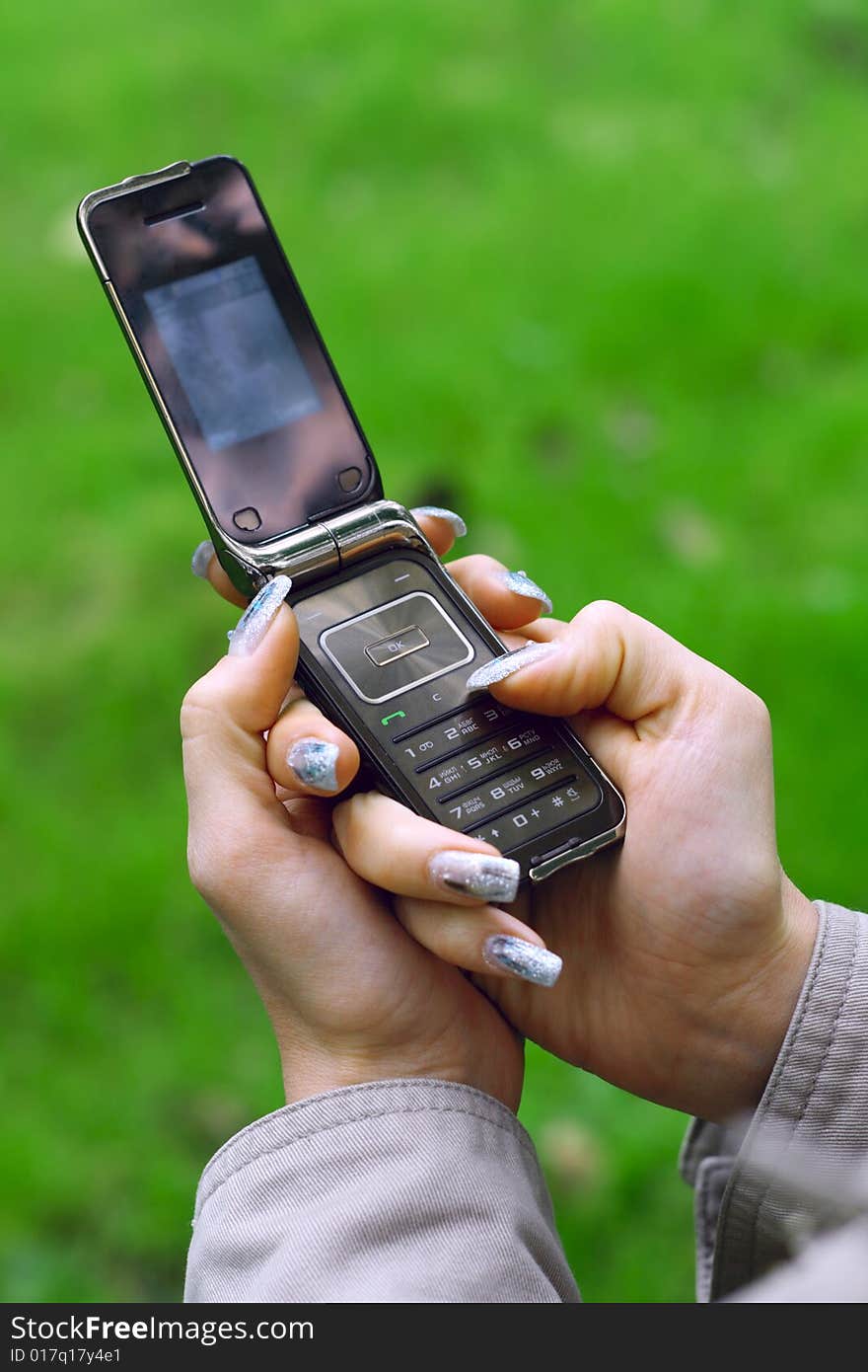 Closup photo of girl holding a mobile phone. Closup photo of girl holding a mobile phone