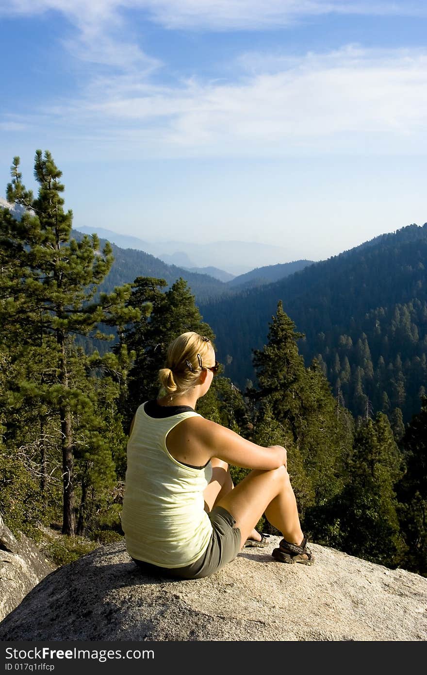 A woman gazing at the incredible view of mountains. A woman gazing at the incredible view of mountains