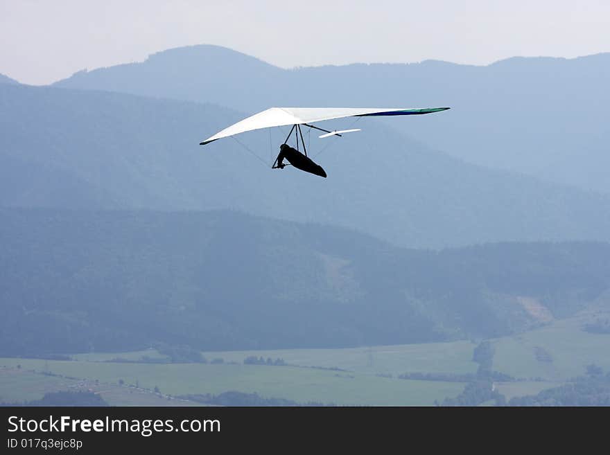 Man with flying wing on sky