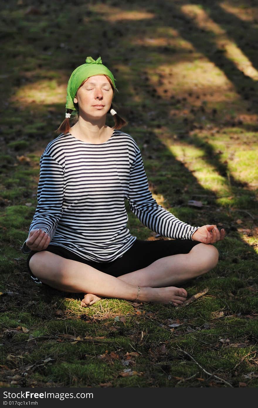 The woman meditates in wood