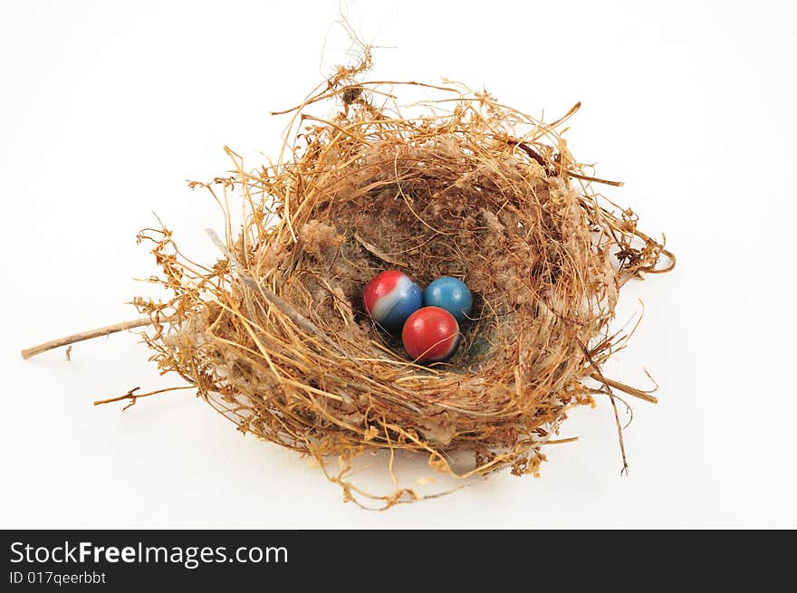 Three marbles in a little bird's nest of twigs. Three marbles in a little bird's nest of twigs