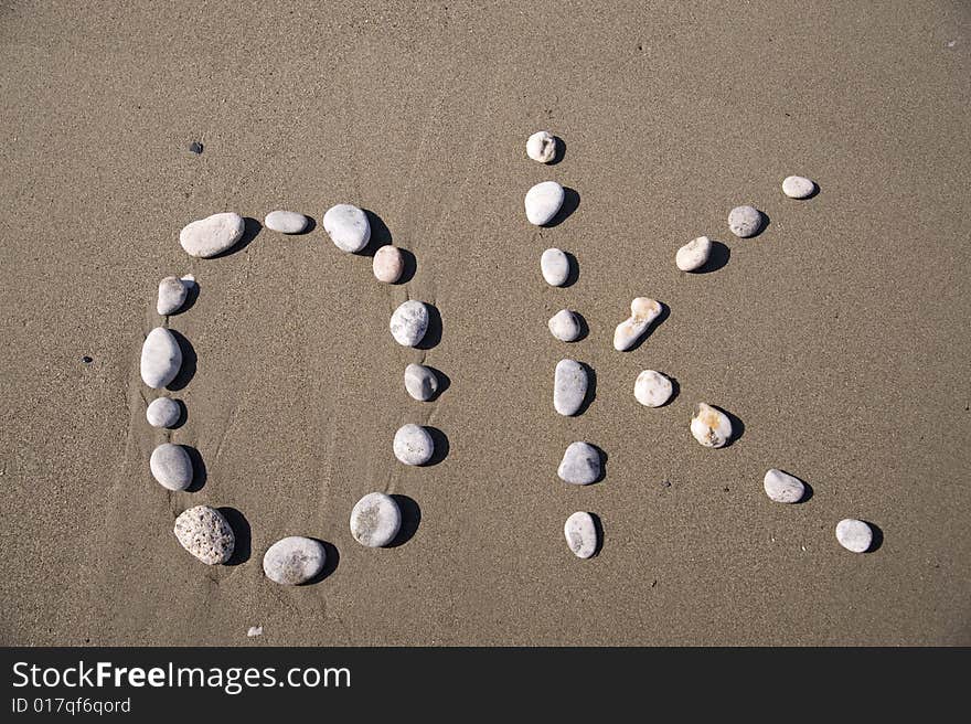 OK inscription on the sand