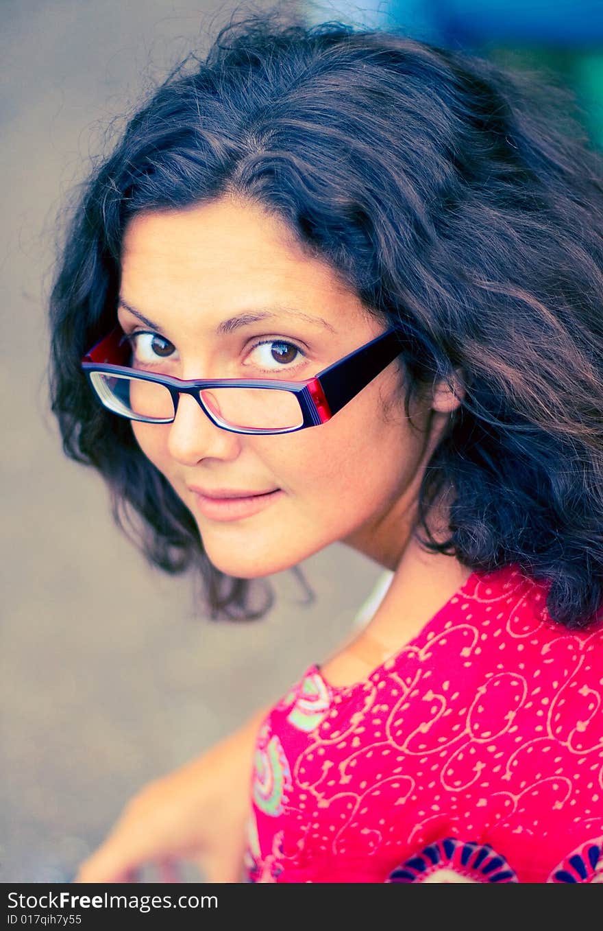 Pretty brunet woman in glasses and red dress