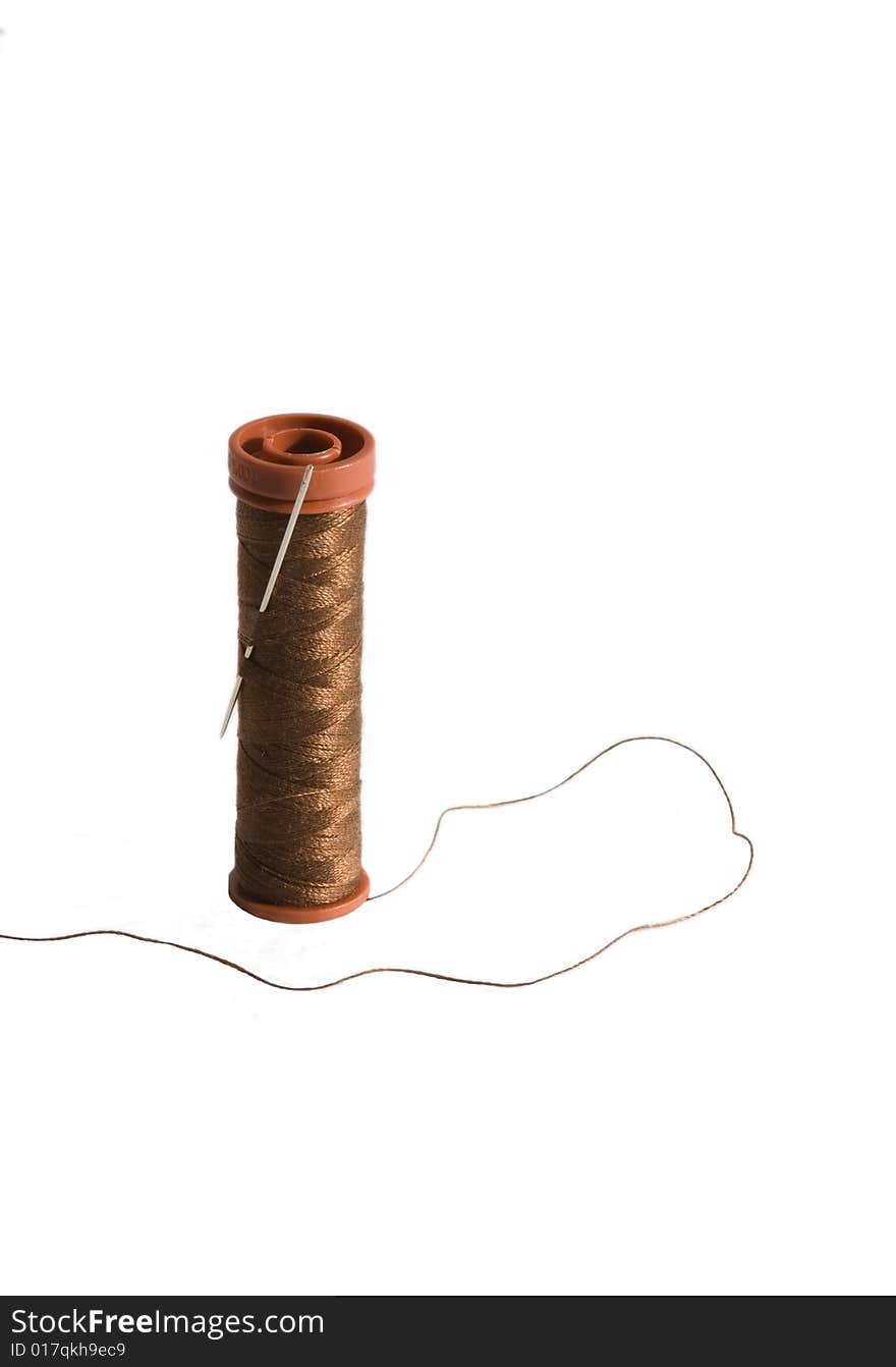 Brown thread and a needle