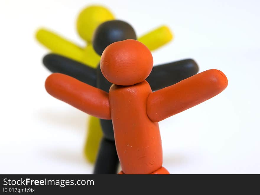 Three plasticine men standing isolated on white background