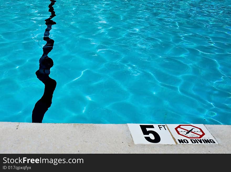 Image of no diving sign at pool side