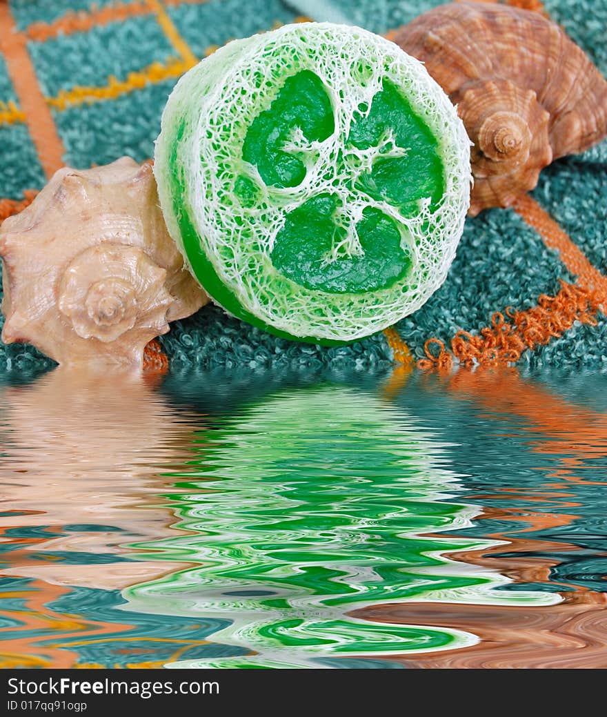 Spa concept - special gren soap and shells over towel. Spa concept - special gren soap and shells over towel