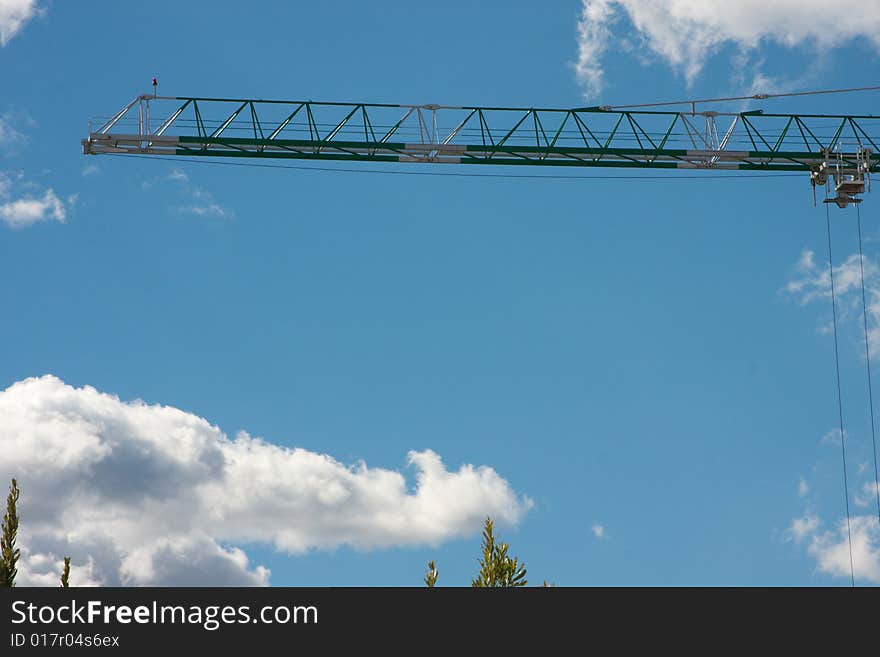 Construction crane on the blue sky