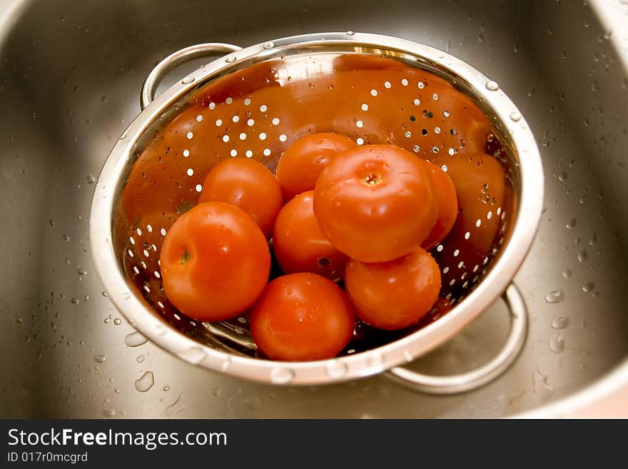 Fresh tomatos in silver strainer