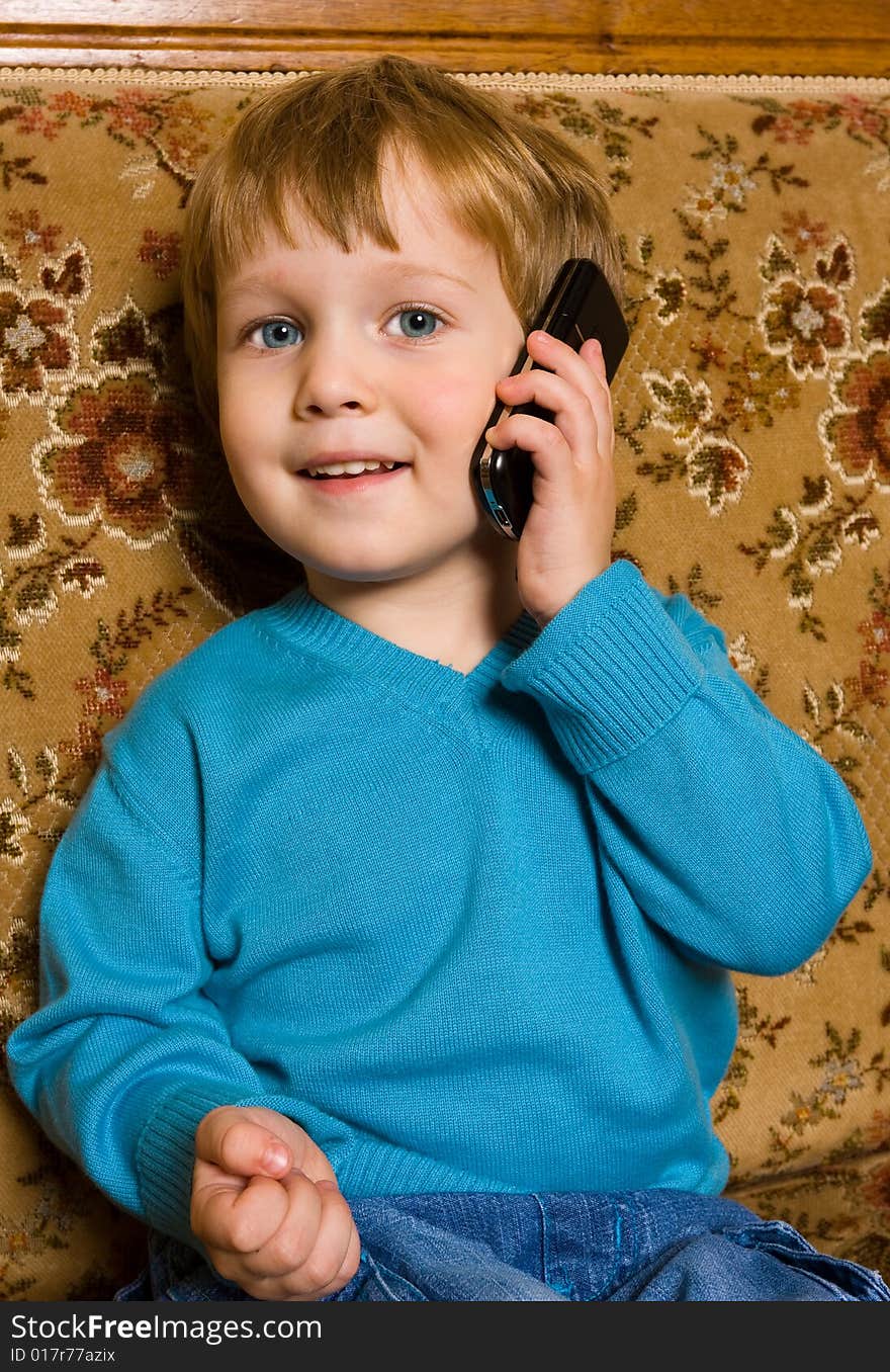 Portrait of adorable baby with mobile phone.