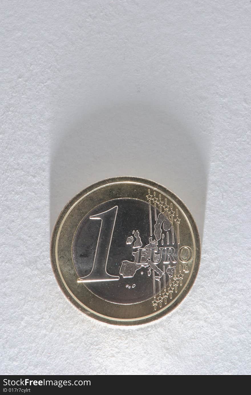 Euro coin on white paper with shadow. Euro coin on white paper with shadow