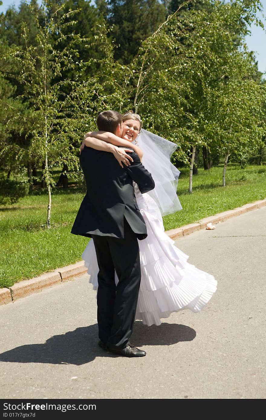 Groom turning his bride on the road. Groom turning his bride on the road