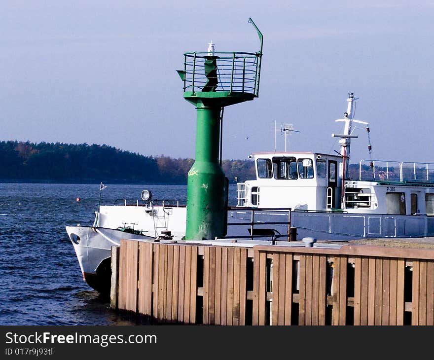 Small Lighthouse And Boat