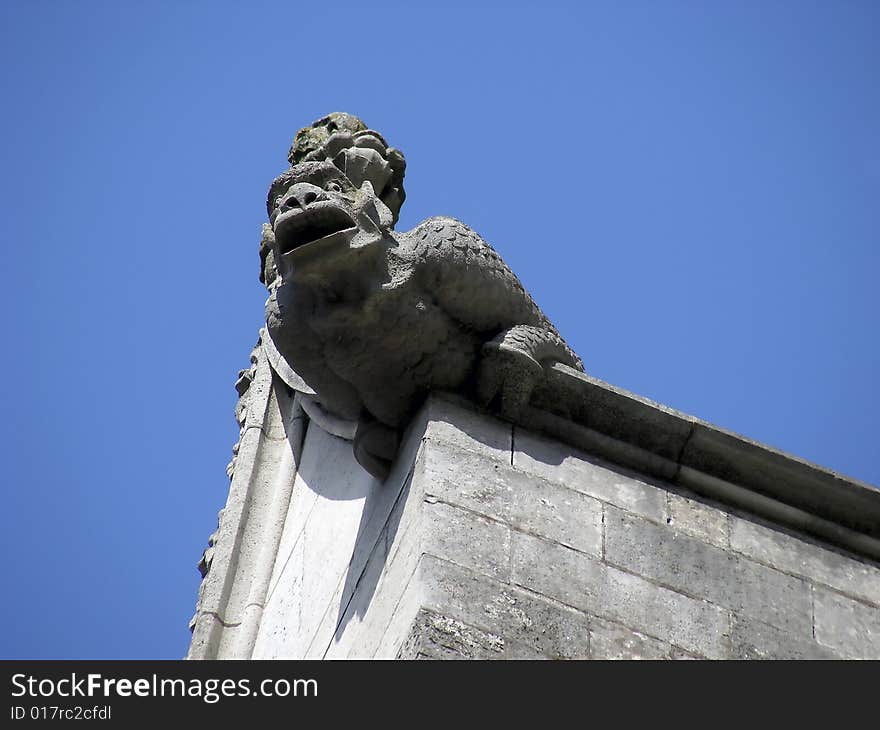 Fierce looking gargoyle on the side of the cathedral at Winchester, England. Fierce looking gargoyle on the side of the cathedral at Winchester, England.