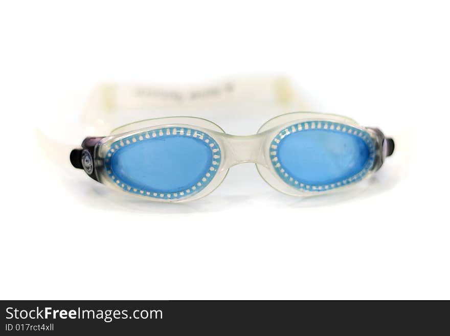 Blue glasses for swim on white background (shallow DOF)