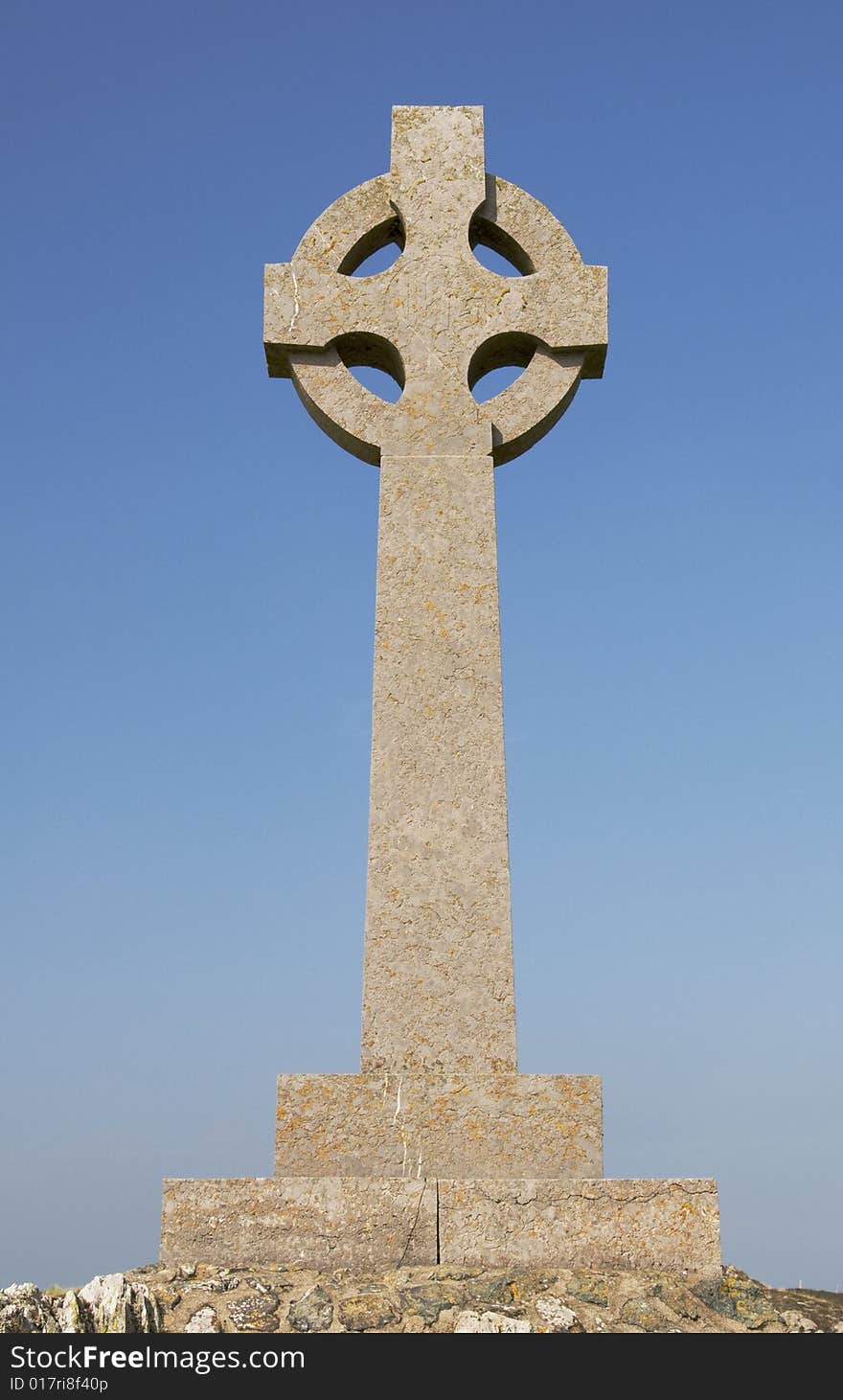 A welsh celtic cross with a blue sky. A welsh celtic cross with a blue sky