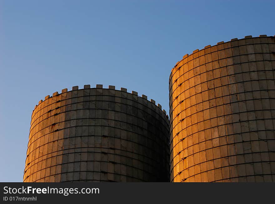 A pair of vintage grain silos at sunset. A pair of vintage grain silos at sunset