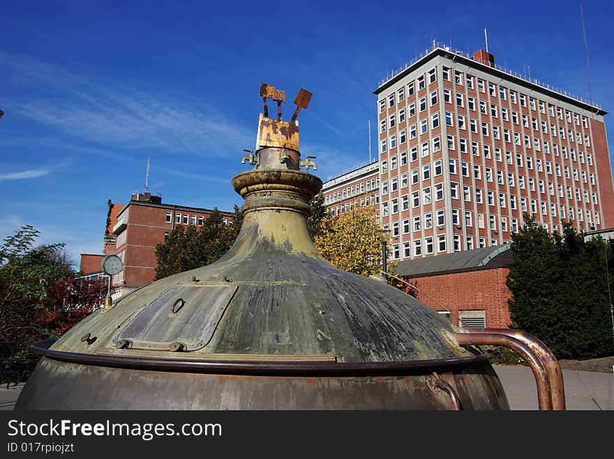 An old spring pot is putted near Hamburg Harbor. The pot may tell an old story of bear producting history of Germany.