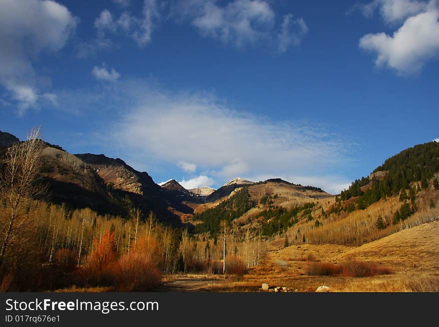 Mountain meadow in the late fall with blue sky and clouds. Mountain meadow in the late fall with blue sky and clouds