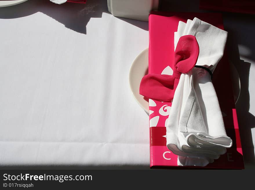 White table cloth with napkin, menu and bread plate. White table cloth with napkin, menu and bread plate.