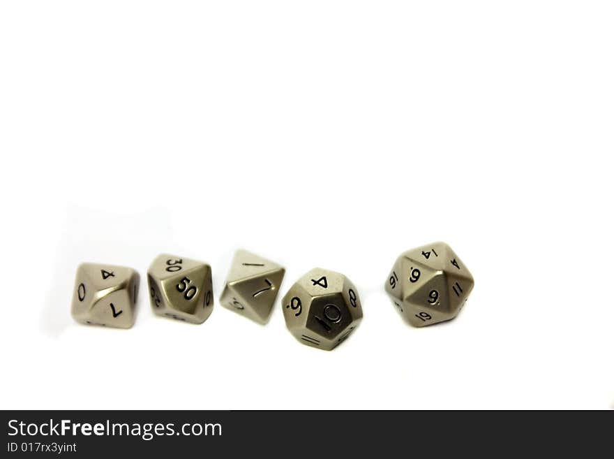 Small metal dice in a row on a white background. Copy space.