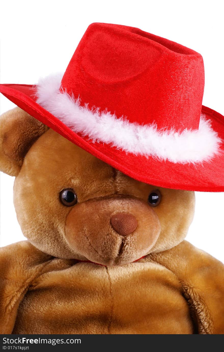 Big brown teddy bear with a santa hat on is head. Big brown teddy bear with a santa hat on is head.