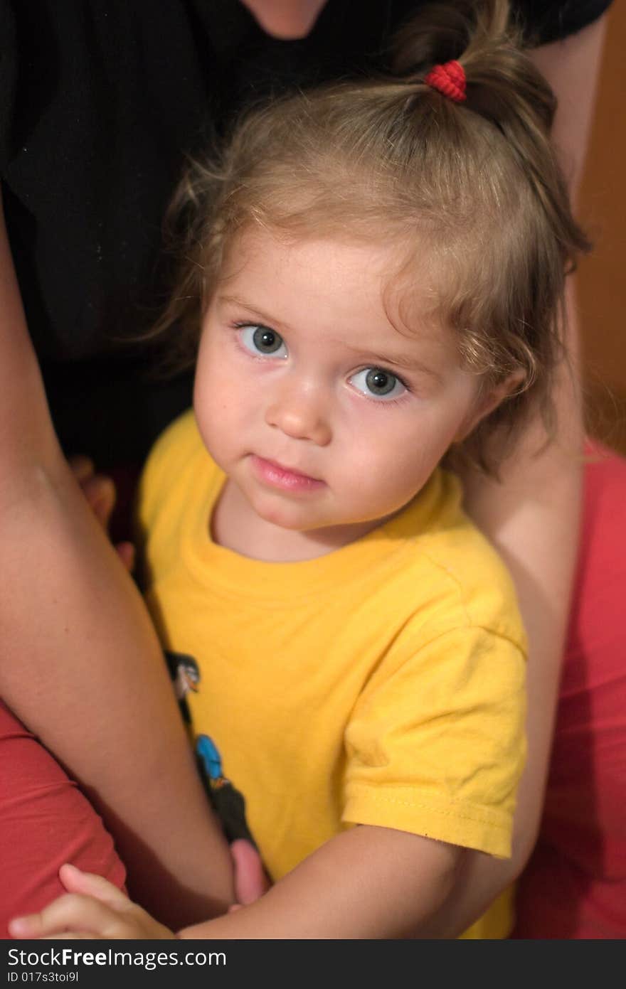 Beautiful little girl on mother's hands