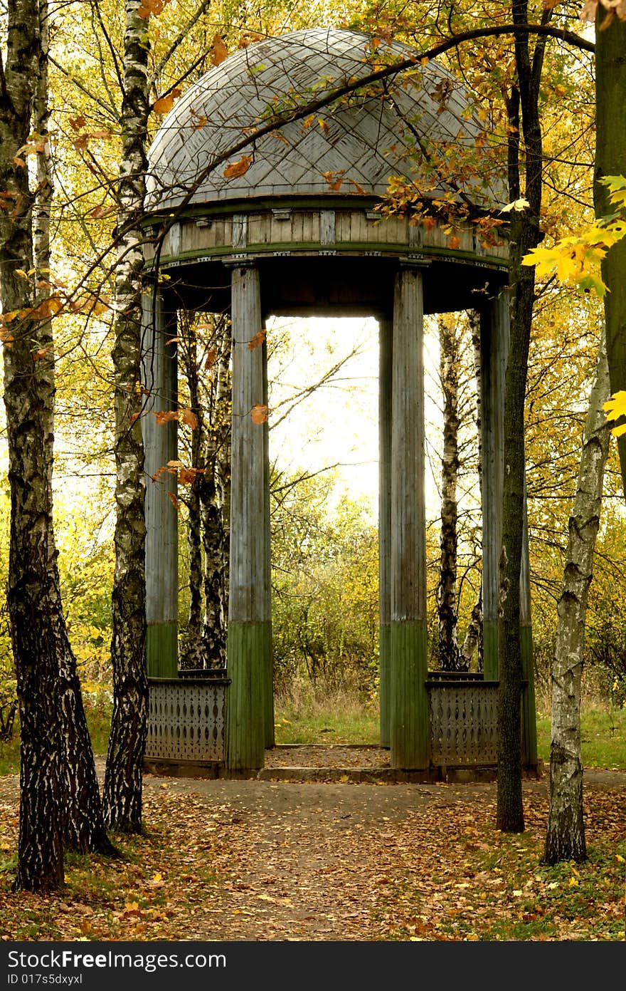 Summer-house on a background of a wood