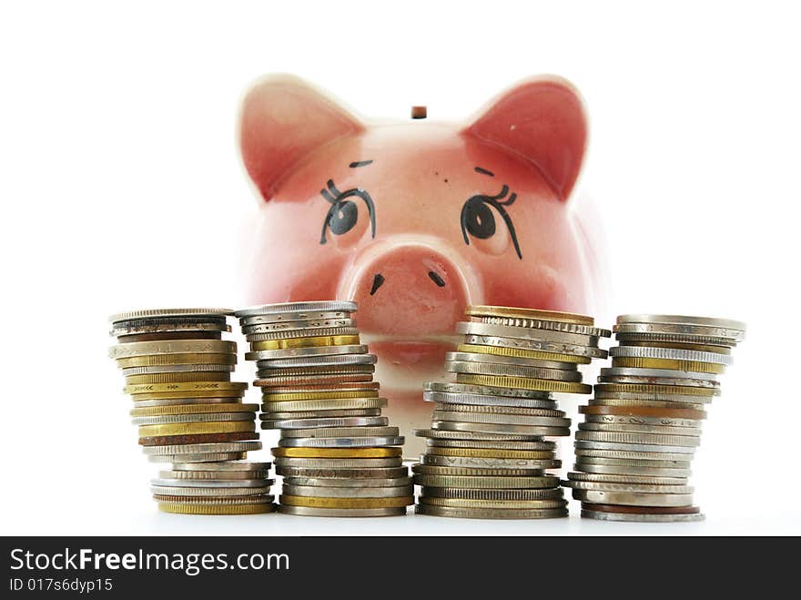 Pink piggy bank isolated on white background with coins. Pink piggy bank isolated on white background with coins