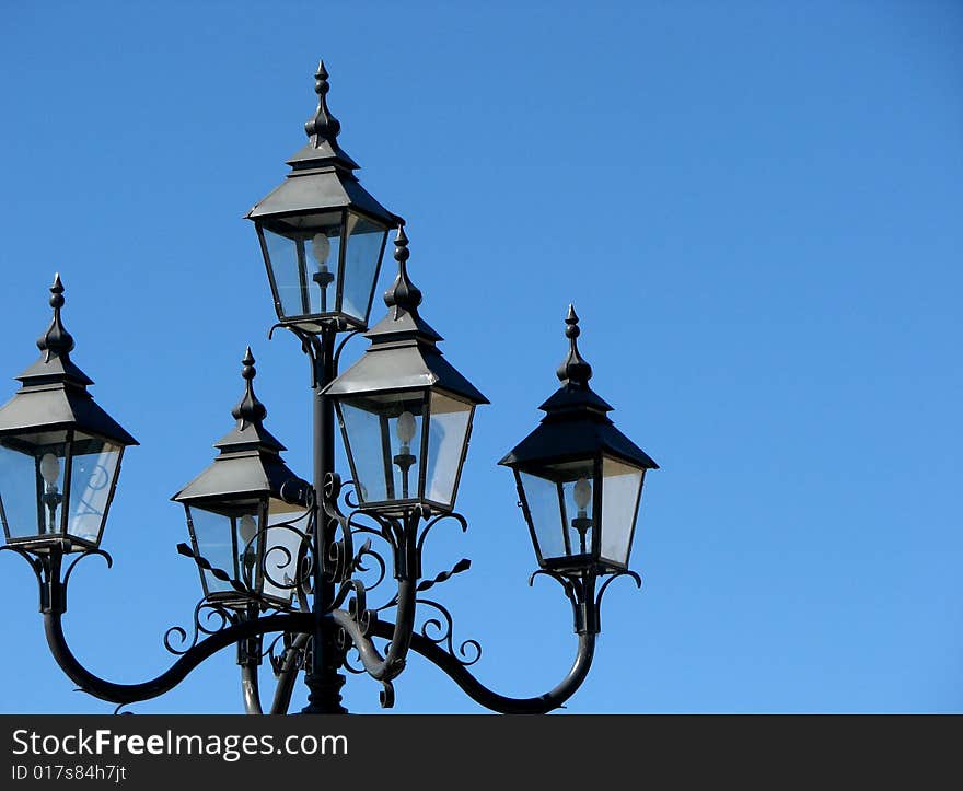 Photograph of outdoor colonial style street lamps. Photograph of outdoor colonial style street lamps.