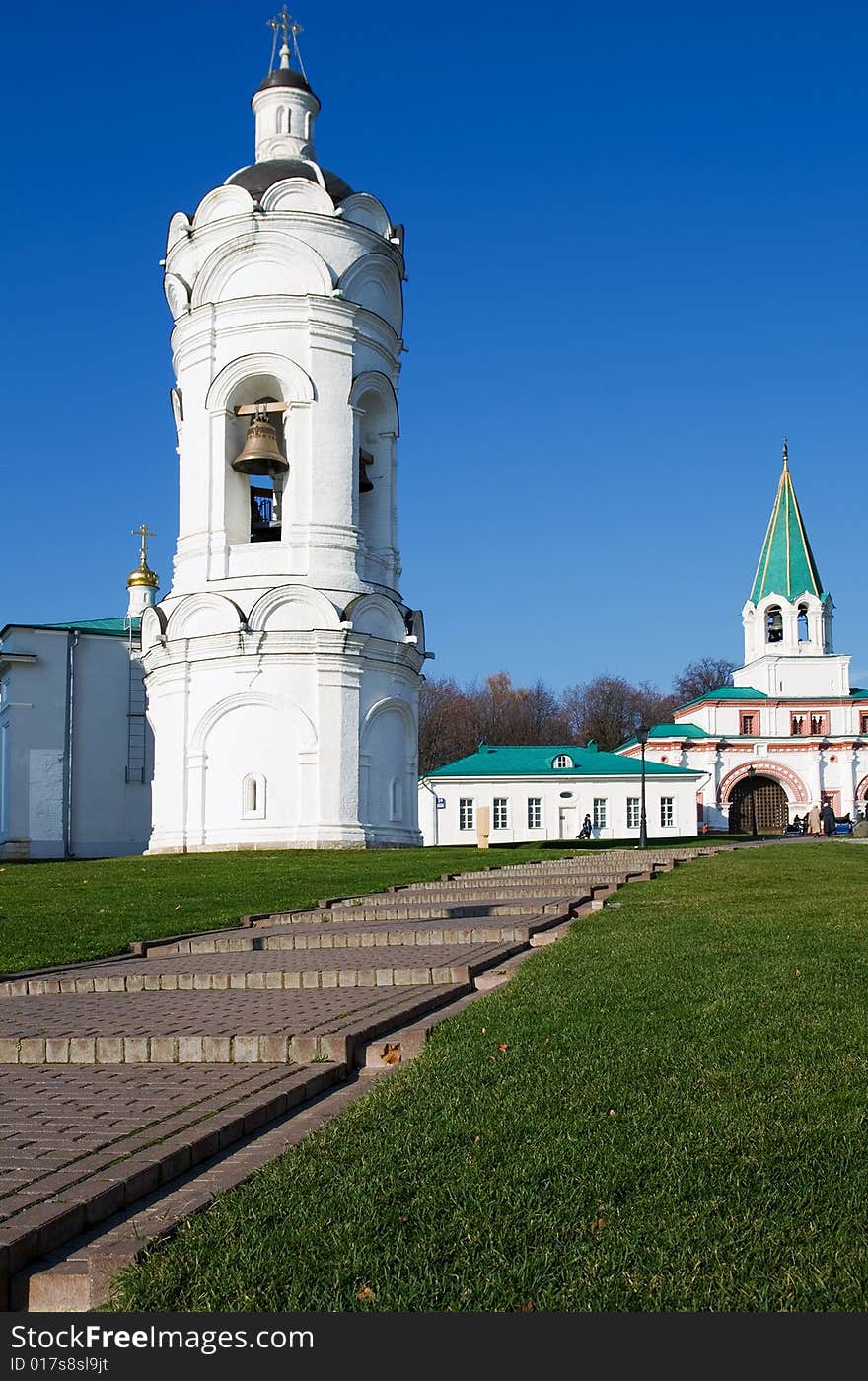 A memorial estate belltower, nearby a ladder, on a distance shot a palace. A memorial estate belltower, nearby a ladder, on a distance shot a palace