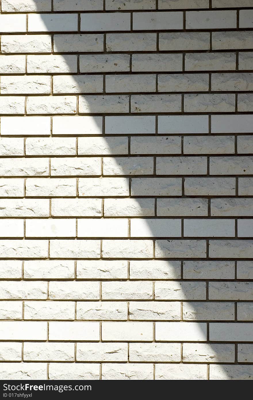 White brick wall with a shadow, background