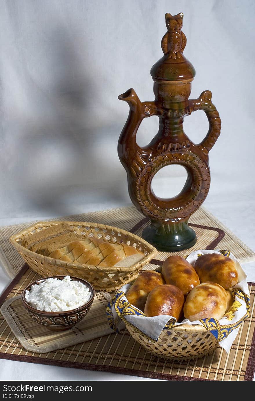 Still-life with pastry, cottage cheese and ceramic vessel. Still-life with pastry, cottage cheese and ceramic vessel