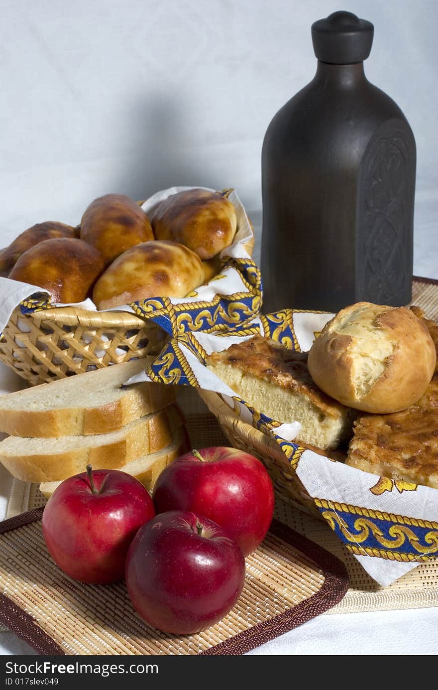 Still-life with pastry, apples and pottery. Still-life with pastry, apples and pottery