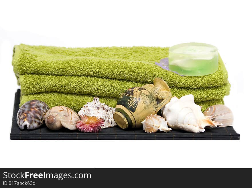 Isolated towels, soap and shells with ancient jug