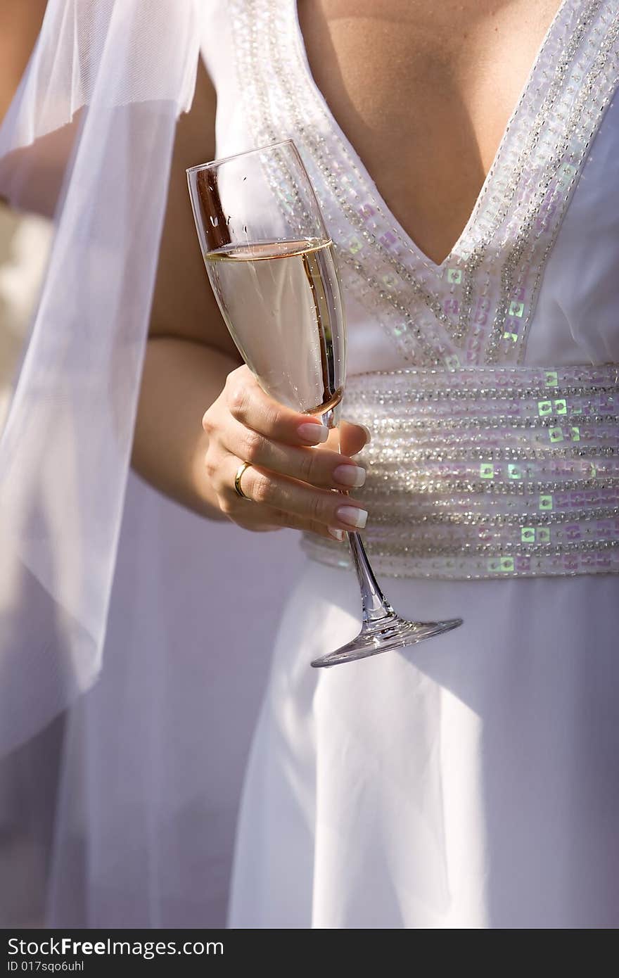 Bride with wine glass during wedding celebrations