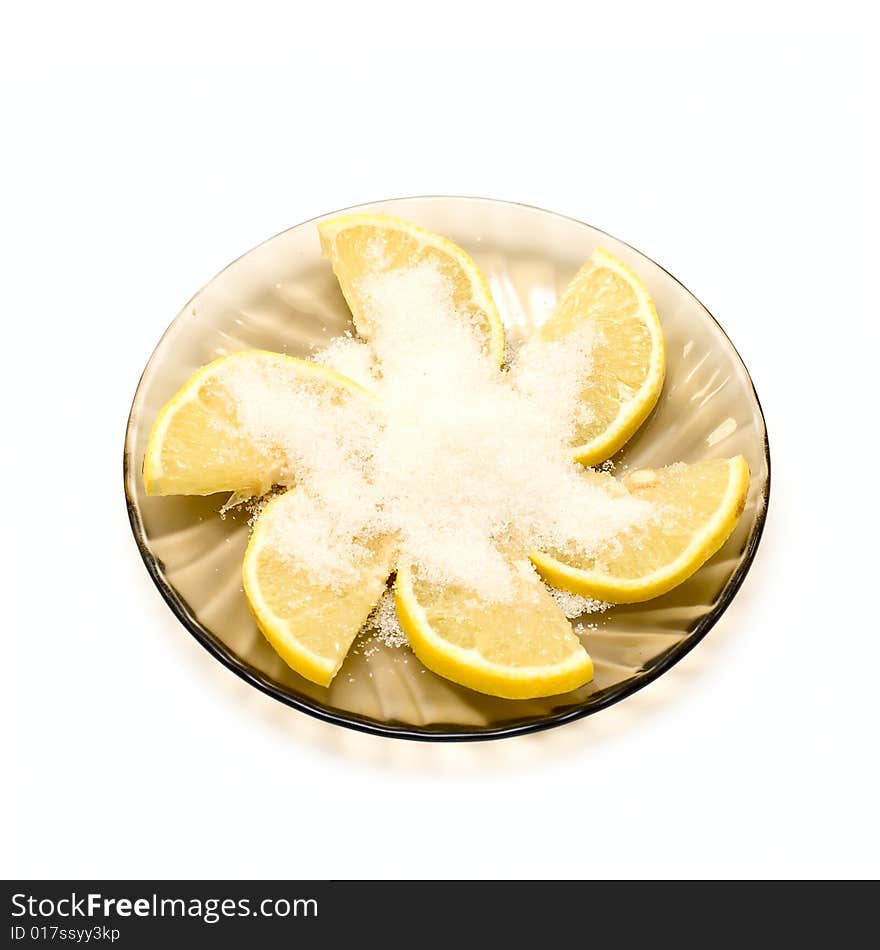 Lemon slices and sugar on plate