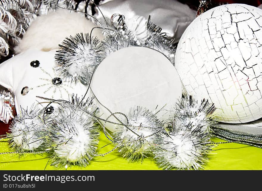 White and silver  christmas decoration on green forground