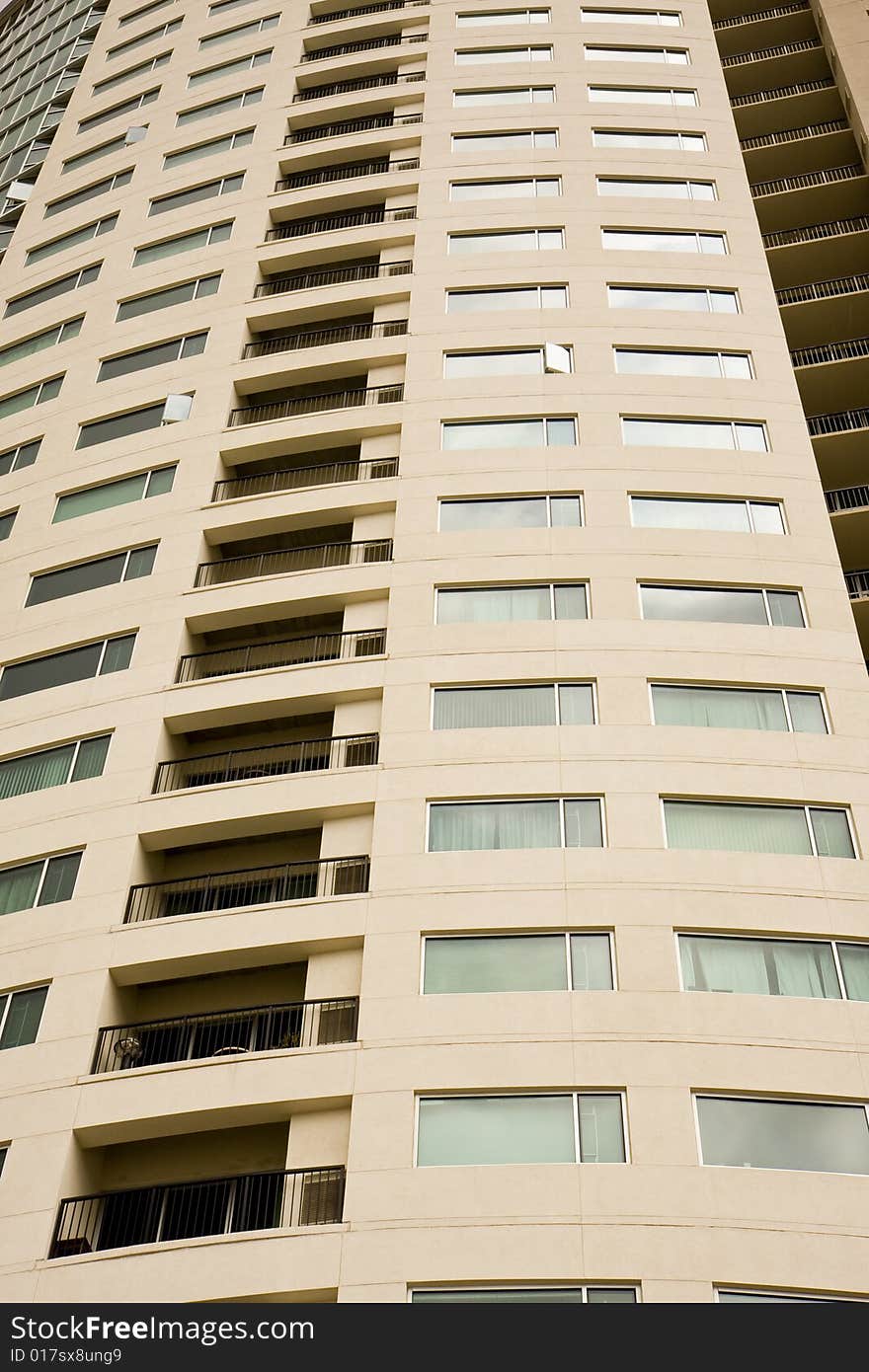 A high rise condominium tower with balconies and windows. A high rise condominium tower with balconies and windows