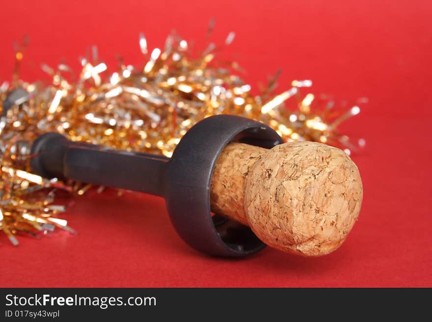 Champagne cork and decorations in red background. Champagne cork and decorations in red background