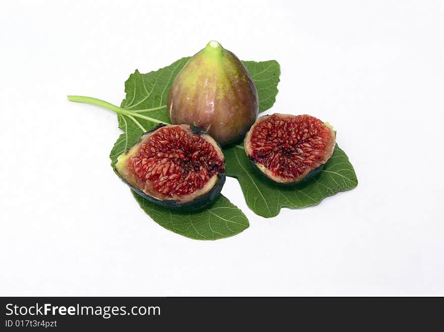 Isolated fig berries with green fig leaf on white background. Isolated fig berries with green fig leaf on white background