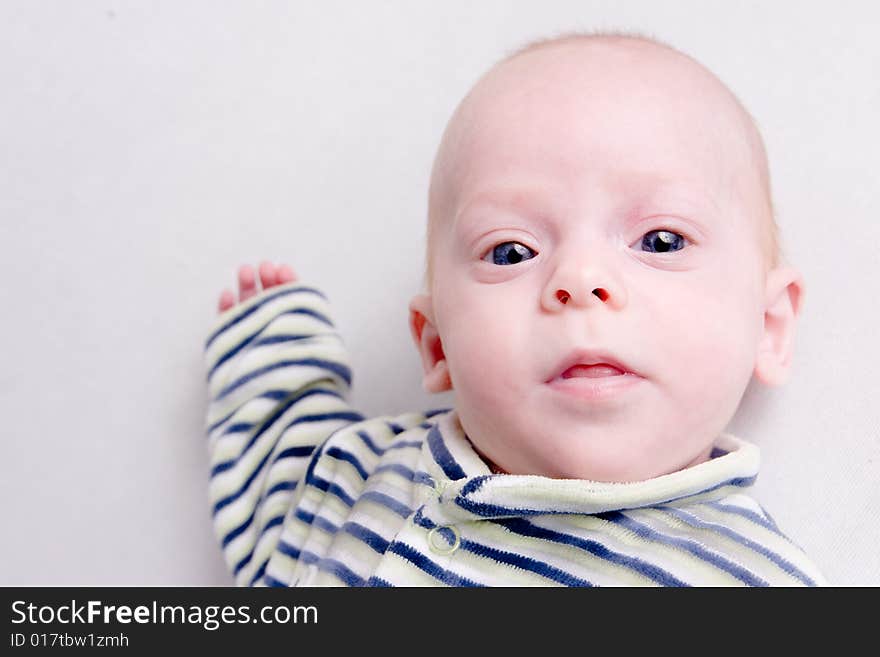 Newborn baby over light background