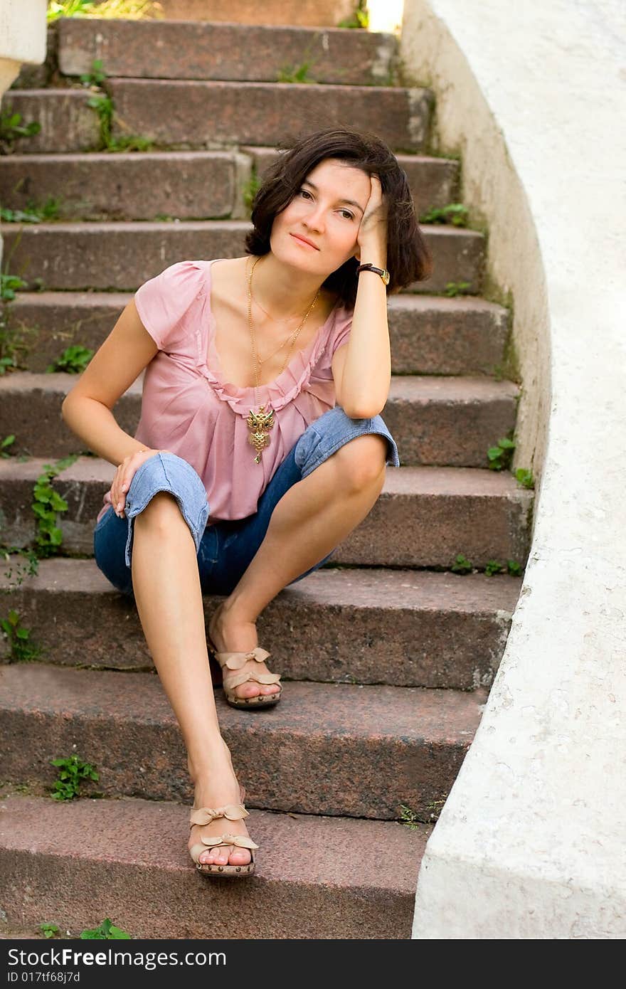 Woman sitting on a staircase