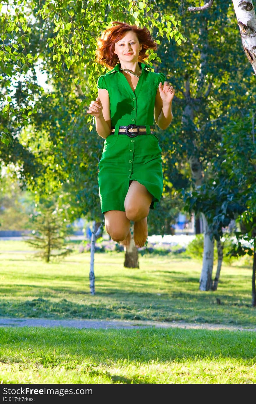 Young beautiful woman jumps with happiness