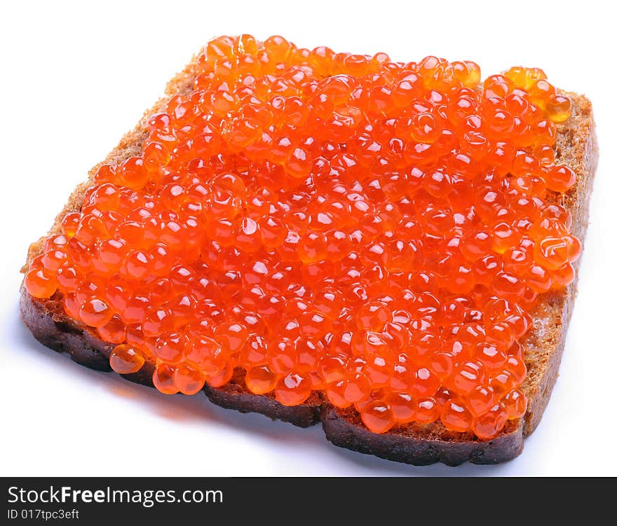 Red caviar on brown bread; Objects on white background. Red caviar on brown bread; Objects on white background